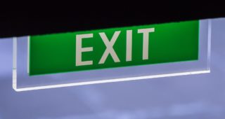 Illuminated Corporate Office Exit Sign Closeup.